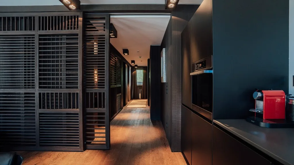 Hallway with wooden slat sliding door and kitchenette with Nespresso machine
