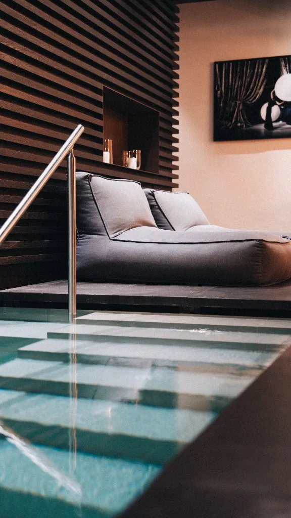 Lounger with candles at the poolside in the spa